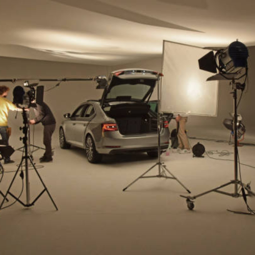 Prague, Czech Republic - 10 February, 2015: Modern car on the professional photo session in photo studio. These workers prepare the car to photos.